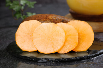 Fresh Yellow Persimmon Fruit Slices on Slate Plate - Healthy Organic Food Photography
