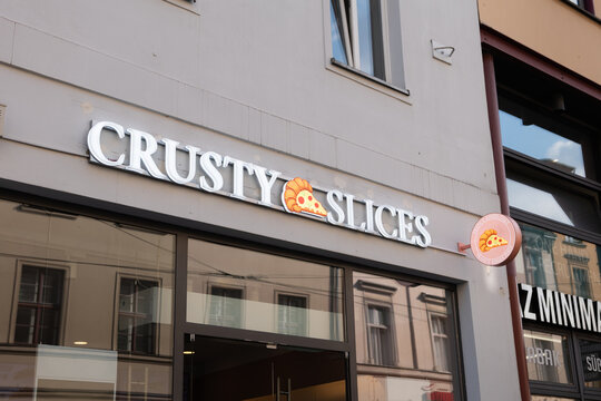 BERLIN, GERMANY - 9. September 2025: Crusty Slices logo sign of the store. New franchise business by Enes Seker, the founder of Royal Donuts. Take away street food and a viral marketing strategy.