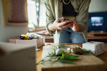 Person using smartphone with jewelry and accessories