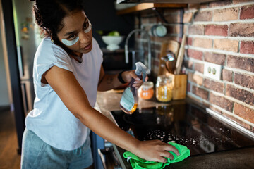 Woman cleaning kitchen surface