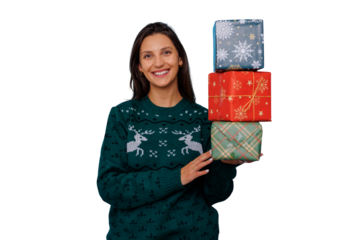 Young woman smiling, holding stack of colorful christmas gifts, wearing holiday sweater, transparent background
