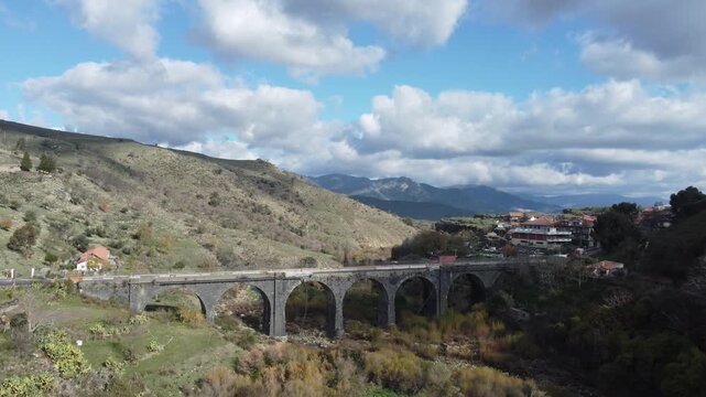 Aerial drone footage of Randazzo in Sicily focusing on the historic center with Basilica di Santa Maria Assunta and the town&rsquo;s medieval architecture, with Mount Etna rising clearly in the background.
