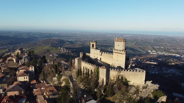 Aerial footage of San Marino during Christmas time, capturing festive markets, decorated streets, historic buildings, and the unique holiday atmosphere of the ancient hilltop city under clear skies.