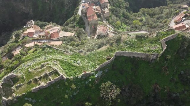 Aerial drone footage of Savoca in Sicily, the historic village famous for The Godfather, showing dramatic clouds, peaceful streets, traditional architecture, and surrounding nature.