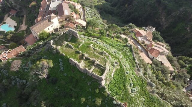 Aerial drone footage of Savoca in Sicily, the historic village famous for The Godfather, showing dramatic clouds, peaceful streets, traditional architecture, and surrounding nature.