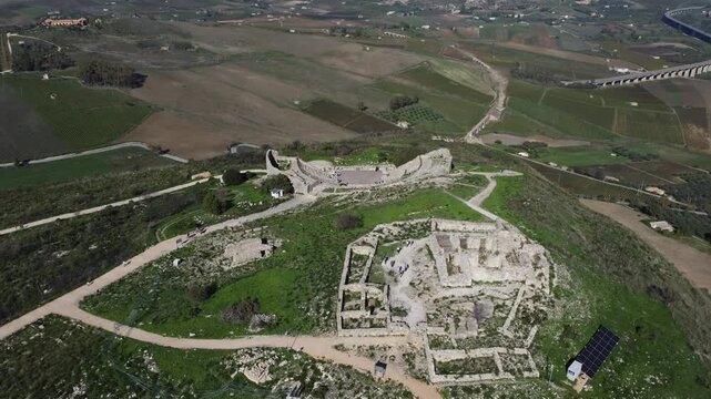 Beautiful 4K footage of Teatro di Segesta in Sicily, showcasing the ancient Greek theatre surrounded by rolling hills, Mediterranean landscapes, and clear summer skies in the Parco Archeologico di Seg