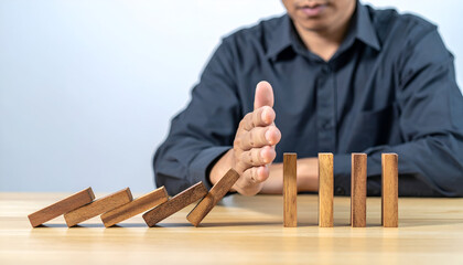 Person steadying a wobbling wooden structure, concept of control, prevention, and business challenges.