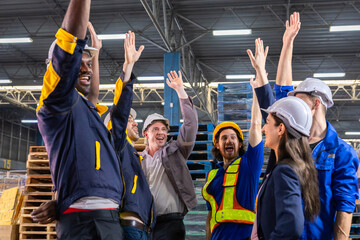 Warehouse teamwork with diverse staff putting hands together, logistics professionals in helmets...