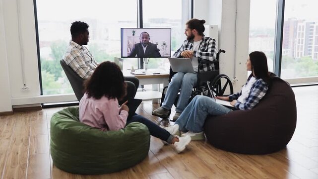 Diverse adult professionals in meeting room engaging in video conference, clapping hands in applause
