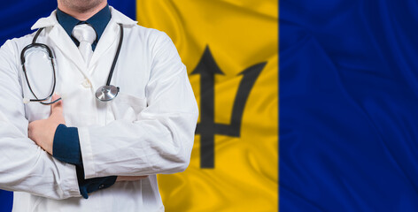 Male doctor with stethoscope on Barbados flag. Doctor holding stethoscope on Barbados flag