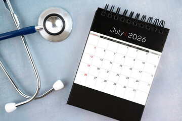 July 2026 calendar and stethoscope, Medical appointment schedule to check up concept.