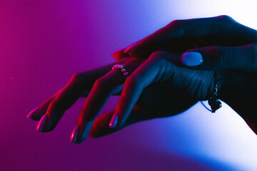 A person's hand reaching for something in the dark.