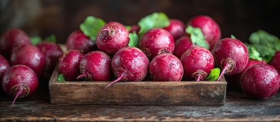 Fresh red beets in a rustic wooden box.