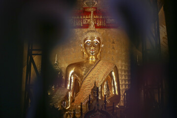 Magnificent golden Buddhist monk statue sacred temple shrine radiates profound peace and spiritual serenity. ancient art sculpture gleams, reflecting deep faith and calm wisdom for traditional