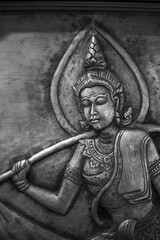 Ancient traditional relief sculpture portraying serene deity figure. cultural art carving expresses peaceful contemplation, showcasing intricate detail and spiritual elegance, reflecting rich