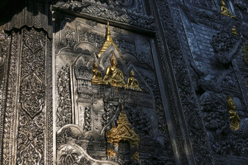 Intricate silver temple carving adorned with ornate gold accents, featuring traditional Thai architectural design. ancient craftsmanship evokes serene sense of heritage and spiritual peace