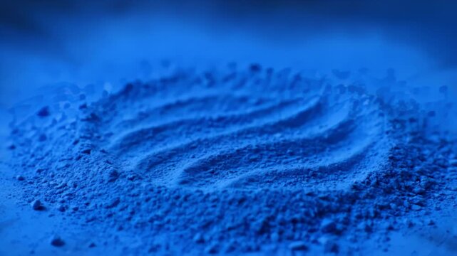 Vibrant Blue Pigment Powder with Wave Texture Design Macro Shot