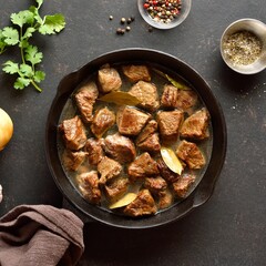 Braised beef in cast iron skillet, top view