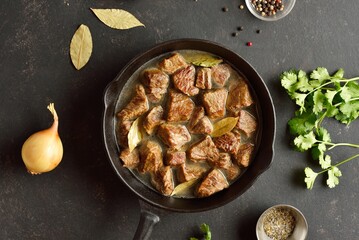Stewed beef in cast iron skillet, top view