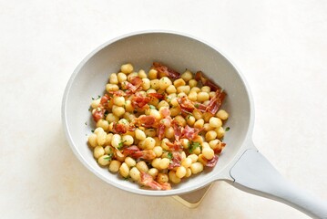 Potato gnocchi with bacon and greens