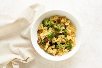 Farfalle pasta with roasted broccoli and mushrooms in bowl