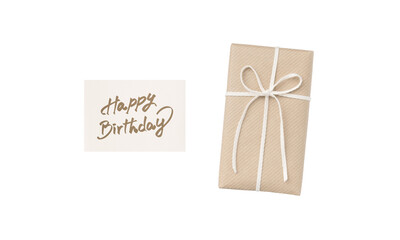Overhead view of a beige gift box with a white ribbon and a happy birthday card with pale brown handwritten text
