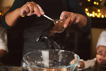 Family Holiday Baking Moment: Hands Pouring Cocoa Into Bowl While Kids Watch