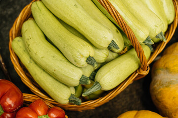 A vibrant and colorful basket brimming with fresh zucchini and various assorted vegetables perfect for healthy cooking