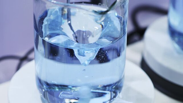 Magnetic stirrer creating a vortex in a laboratory beaker