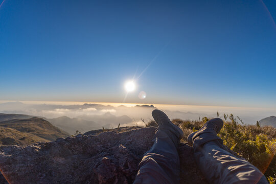 A hiker enjoys the sunset at Pedra do A&ccedil;u along the Petr&oacute;polis&ndash;Teres&oacute;polis trail.
