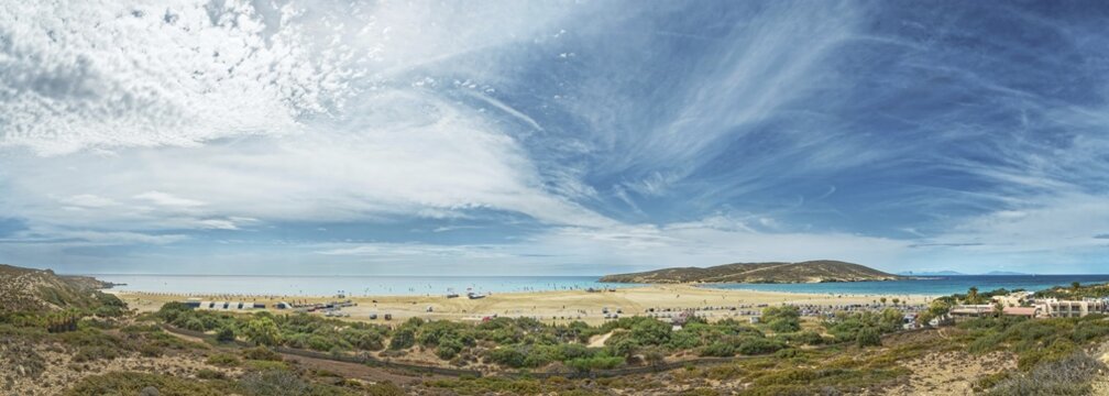Panoramic view of the wide beach of Prasonisi with blue sea and dramatic sky full of clouds, Prasonisi, Rhodes Island, Greece