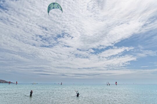 Prasonisi's expansive sea under a big sky with kitesurfers. Lively, sporty atmosphere, Prasonisi, Rhodes Island, Greece