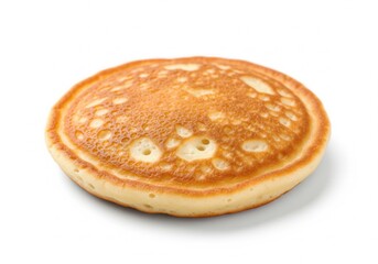 A single, small, fluffy pancake with a golden-brown, porous surface is captured close-up. Isolated white background.