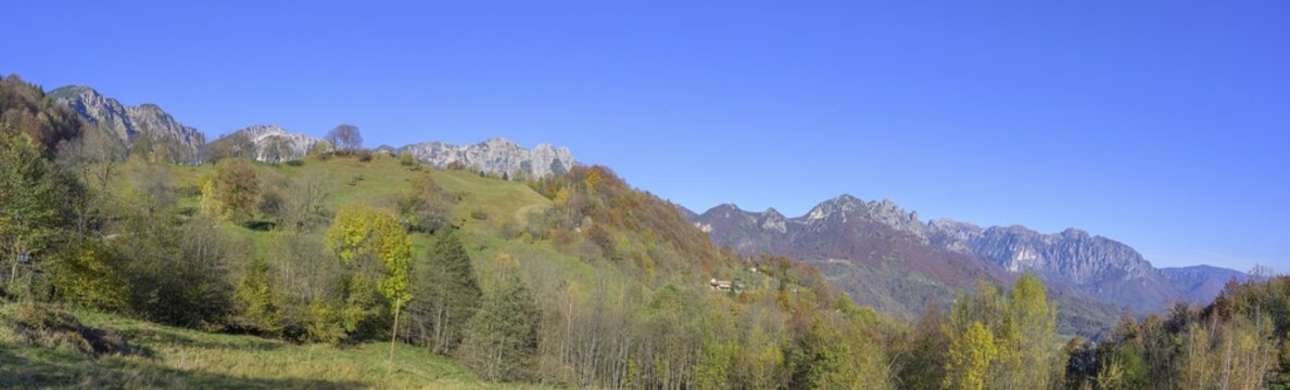 Autumn colours with a view towards the mountain range with Refugio Achille Papa, Piccolo Dolomiti, Recoaro Terme, Province of Vicenza, Italy