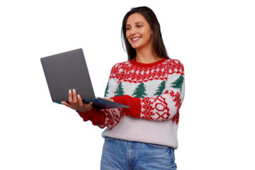 Woman in christmas sweater using laptop, smiling during holiday season, connecting digitally, studio background transparent