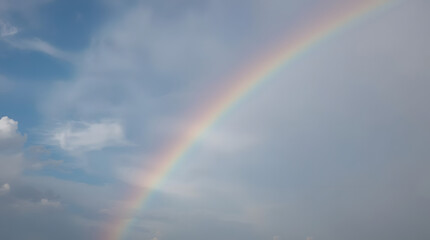 Rainbow's End: Capturing the ephemeral beauty of a vibrant rainbow arching across a cloudy sky, a spectacle of color and light that symbolizes hope and promise.