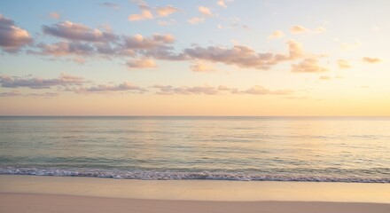 Obraz premium Serene coastal view at golden hour, featuring calm ocean waters, a soft sandy beach, and a sky with delicate pastel clouds, evoking peace and relaxation