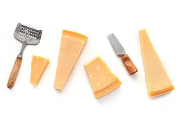 Parmesan cheese wedges, isolated on a white background, overhead flat lay shot with a cheese grater and a knife
