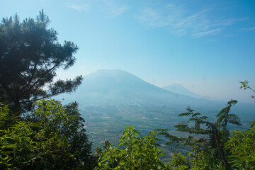 Beautiful Mountain Landscape with Haze and a Lush Green Valley Below
