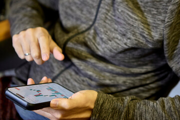 Grey hoodie man using smartphone with both hands