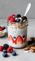 Close-up of overnight oats jar with berries, nuts, and spoon