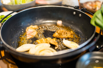 Japanese traditional cuisine, cooking Sukiyaki, stir fried vegetables with meat