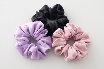 Three Pastel-Colored Scrunchies on Plain Background – Hair Accessory Product Photography.