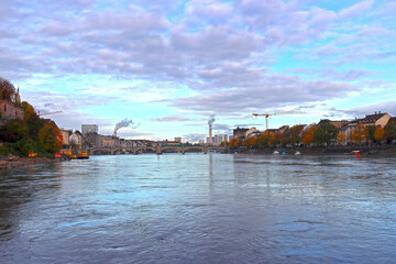 Industry with smoking chimneys in the city, river view (Basel, Switzerland)