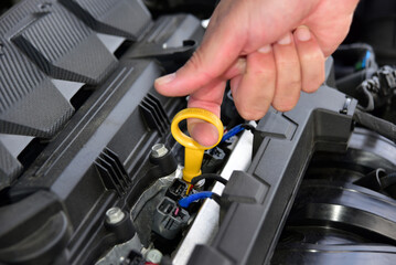 Checking the oil level in the car engine
