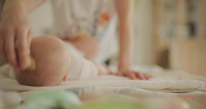 Mother Grooming Newborn on Changing Table