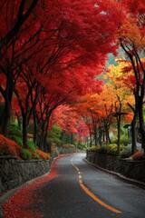 Naklejka premium Road lined with vibrant autumn trees, creating a colorful canopy, leaves scattered