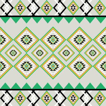 Traditional seamless geometric diamond pattern in tribal ethnic style with green, yellow, black, and white colors. Perfect for fabric, textile, wallpaper, wrapping paper, and digital background design