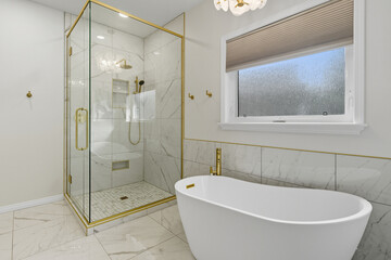Bathroom with a gold shower stall and a white bathtub