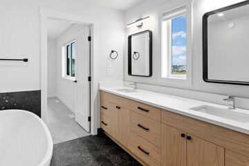 Bathroom with a large mirror and two sinks